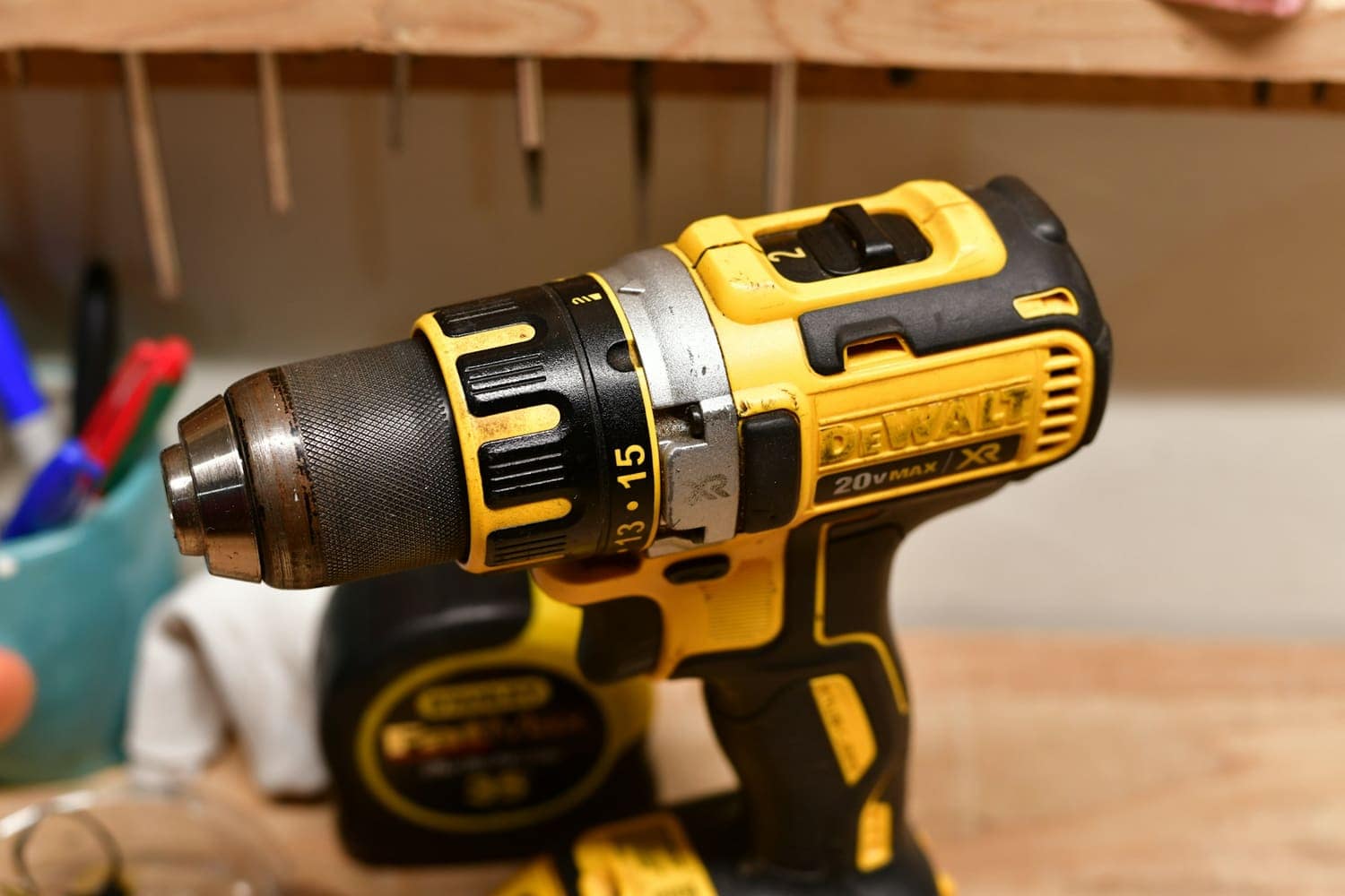 A yellow cordless power drill on a workbench