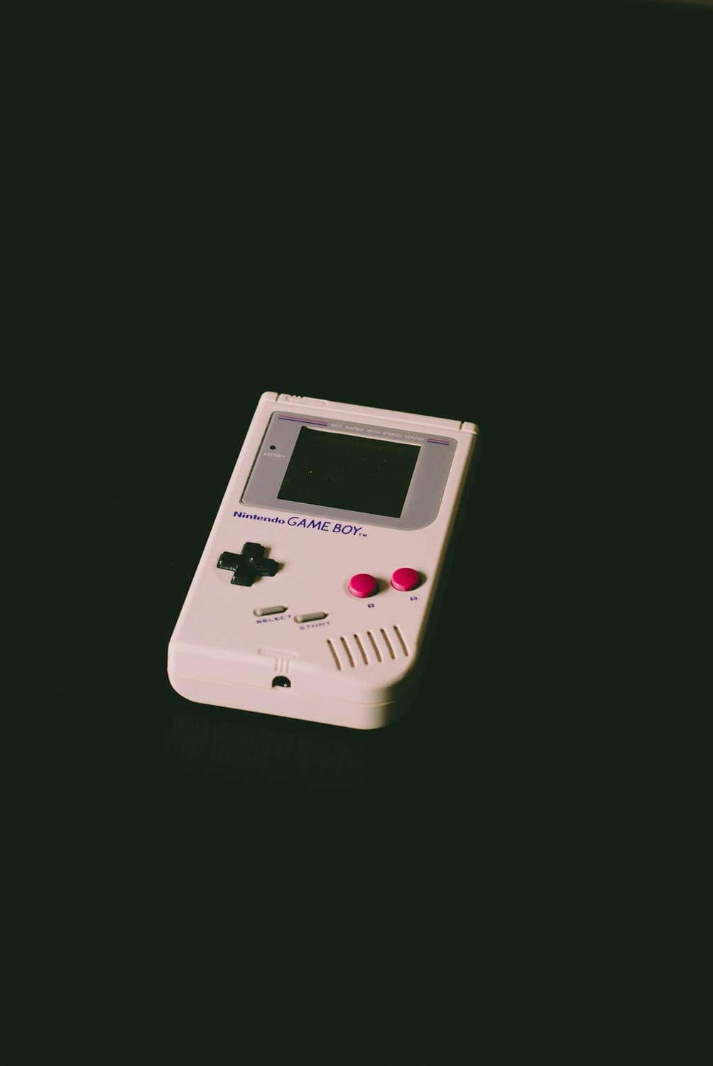 A Game Boy on a deep green background