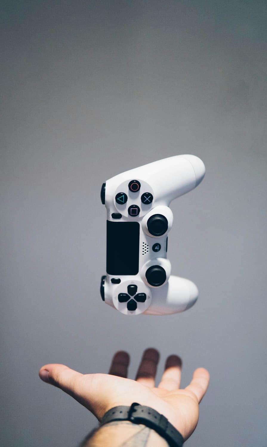 White game controller floating against a grey background