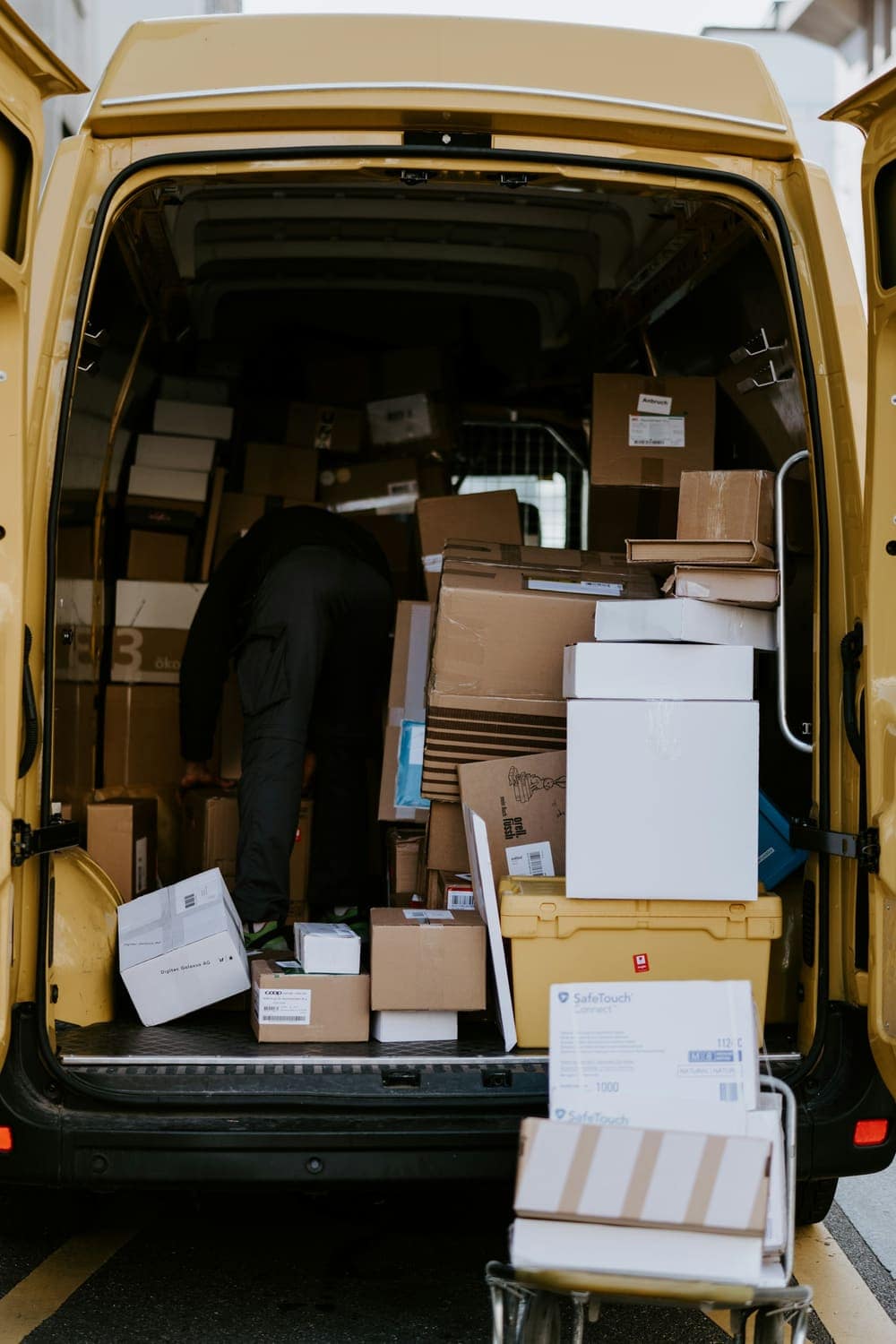 A delivery van loaded with cardboard boxes